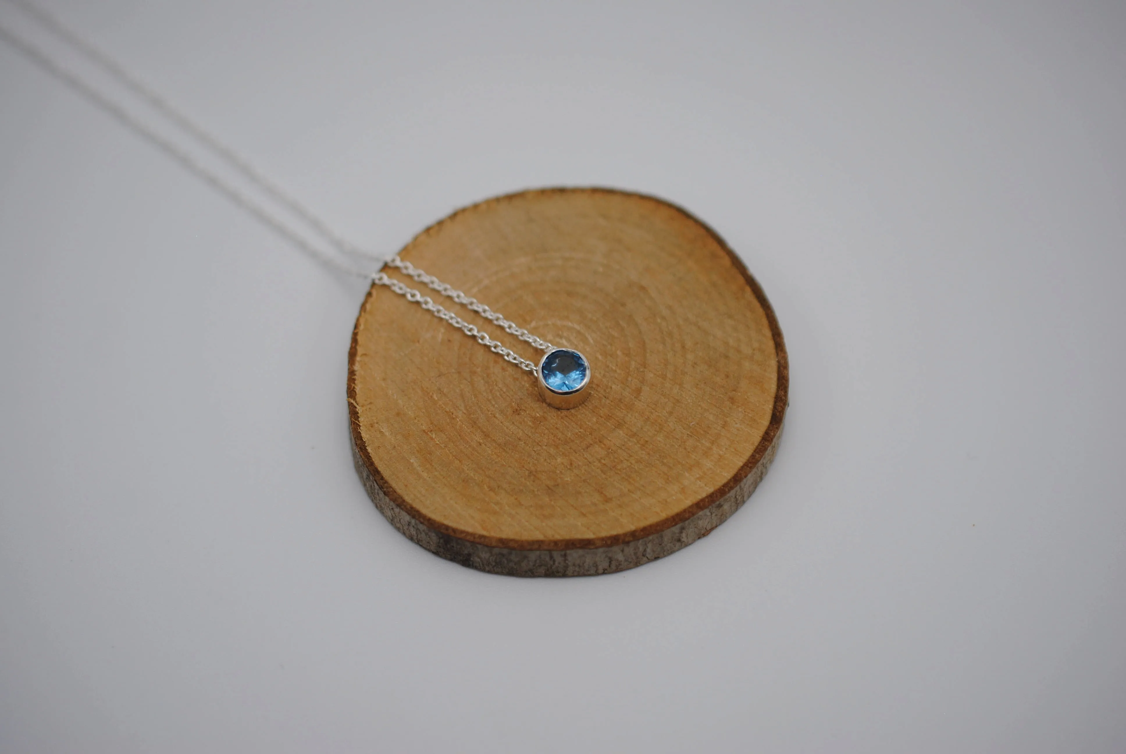 Birthstone Necklace: Round Blue Zircon, Bezel, Silver, Cable Chain