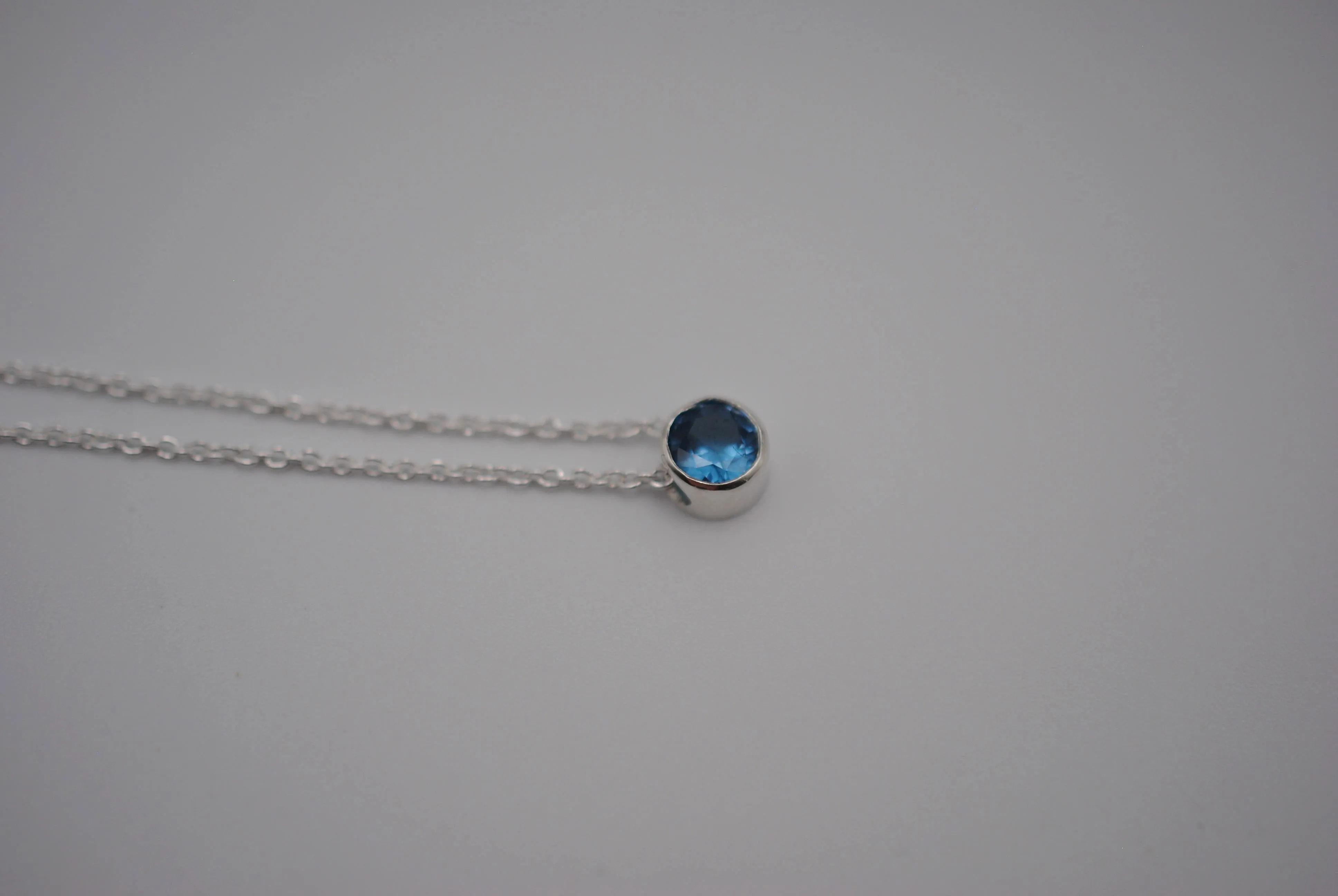 Birthstone Necklace: Round Blue Zircon, Bezel, Silver, Cable Chain
