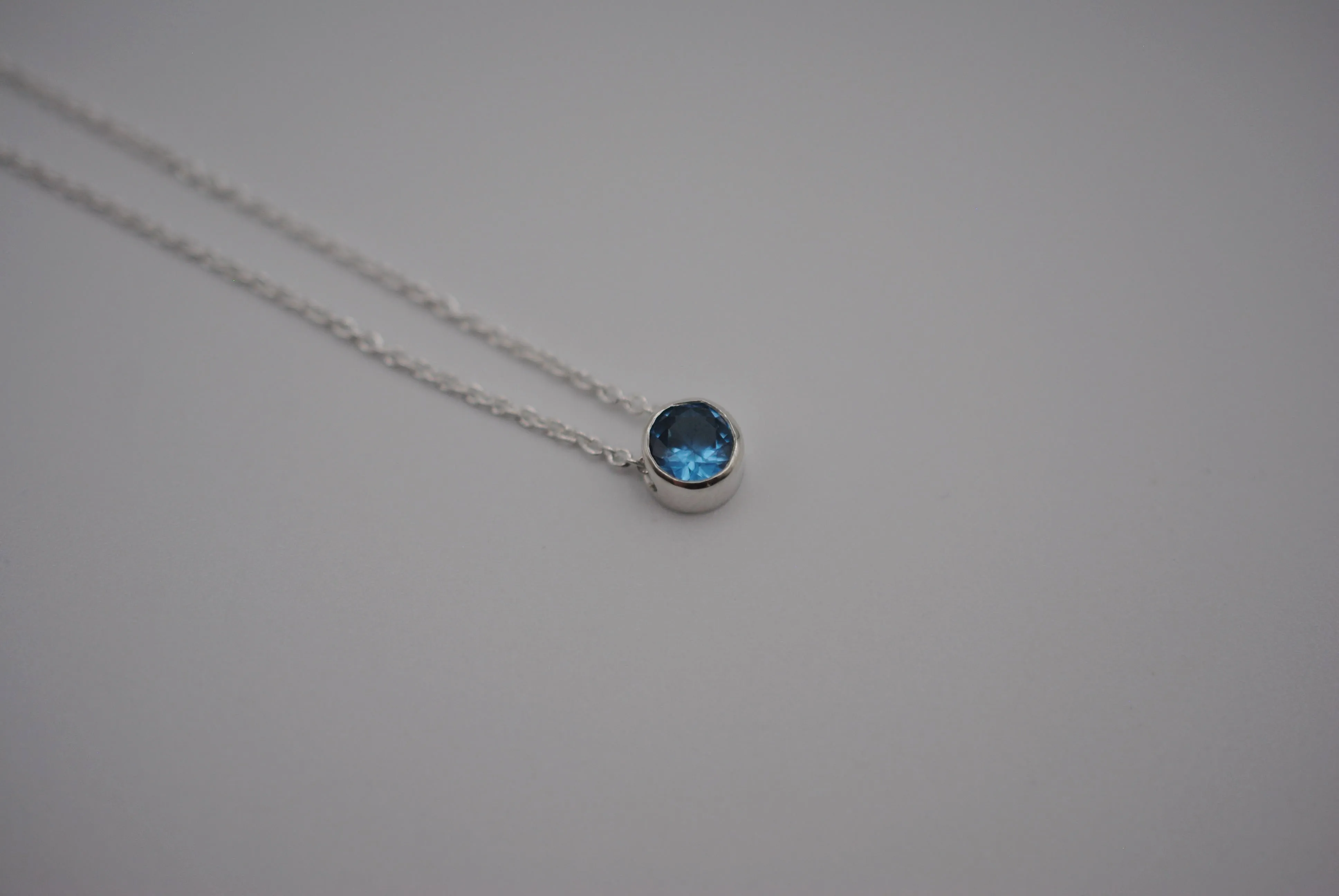 Birthstone Necklace: Round Blue Zircon, Bezel, Silver, Cable Chain