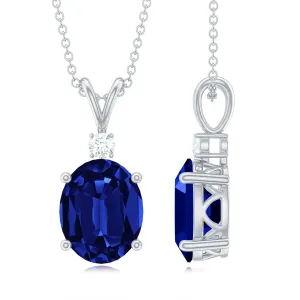 Oval Created Blue Sapphire Solitaire Pendant with Dainty Moissanite